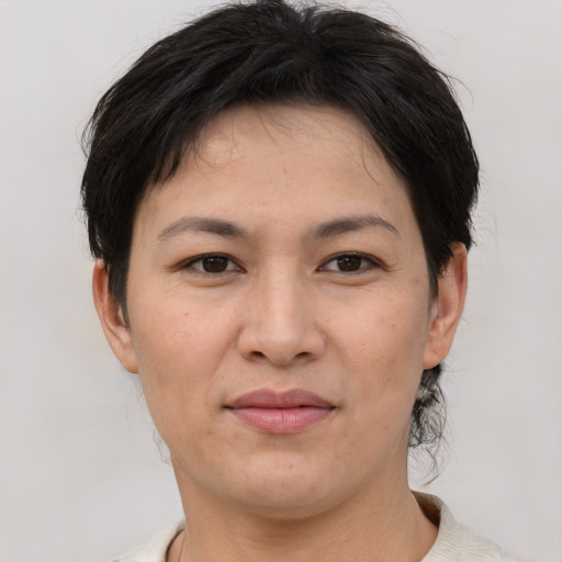 Joyful asian adult female with short  brown hair and brown eyes