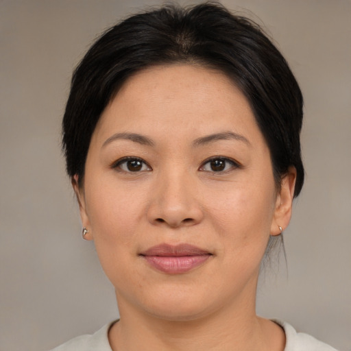 Joyful asian adult female with medium  brown hair and brown eyes