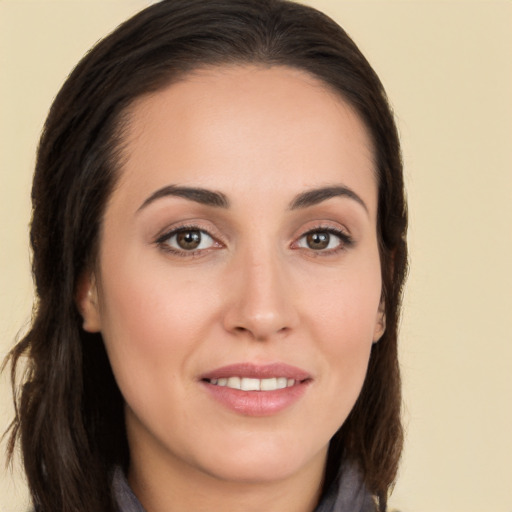 Joyful white young-adult female with long  brown hair and brown eyes