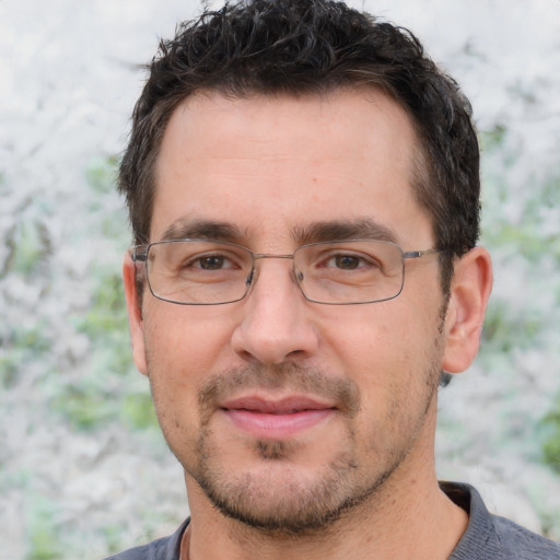 Joyful white adult male with short  brown hair and brown eyes