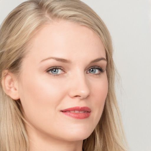 Joyful white young-adult female with long  blond hair and brown eyes