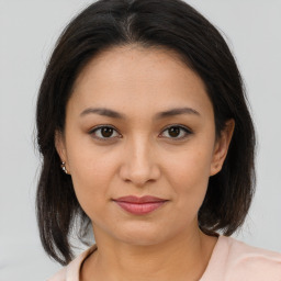 Joyful asian young-adult female with medium  brown hair and brown eyes