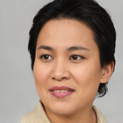 Joyful asian young-adult female with medium  brown hair and brown eyes