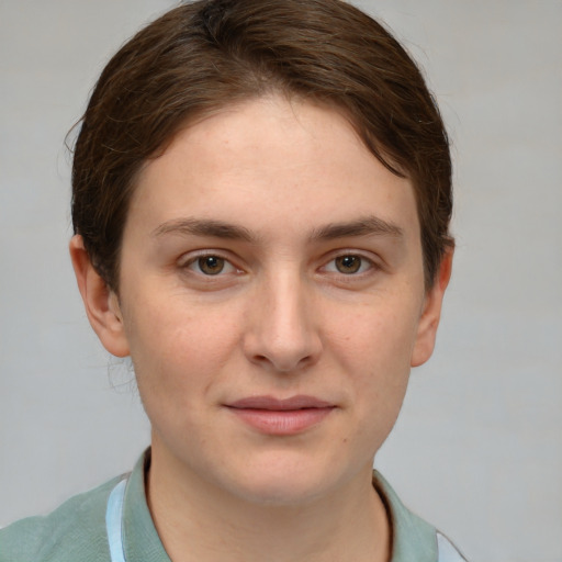 Joyful white young-adult female with short  brown hair and grey eyes