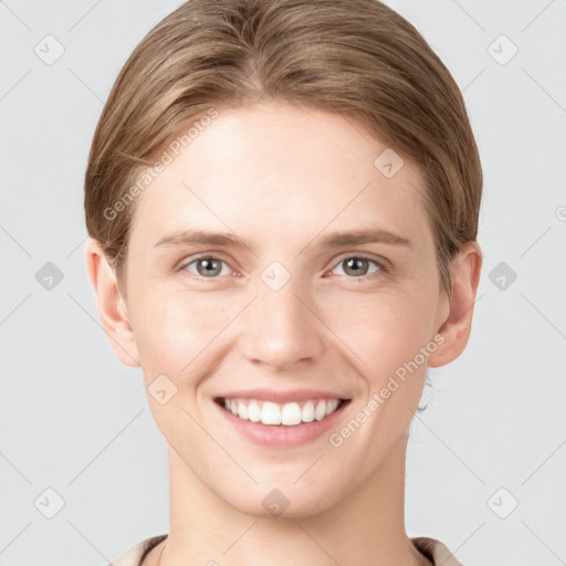 Joyful white young-adult female with short  brown hair and grey eyes