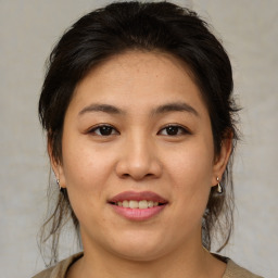 Joyful asian young-adult female with medium  brown hair and brown eyes