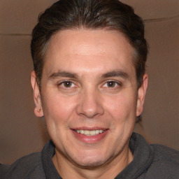 Joyful white adult male with short  brown hair and brown eyes