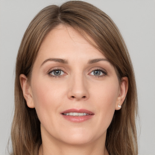 Joyful white young-adult female with long  brown hair and grey eyes