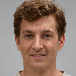 Joyful white adult male with short  brown hair and brown eyes