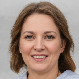 Joyful white adult female with medium  brown hair and brown eyes