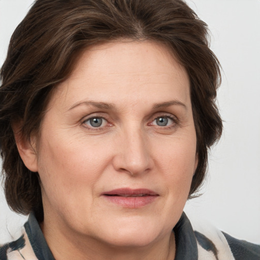 Joyful white adult female with medium  brown hair and grey eyes