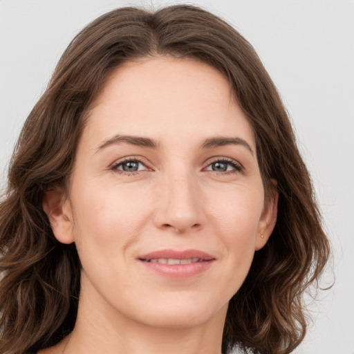 Joyful white young-adult female with medium  brown hair and green eyes