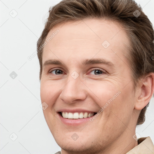 Joyful white young-adult female with short  brown hair and grey eyes