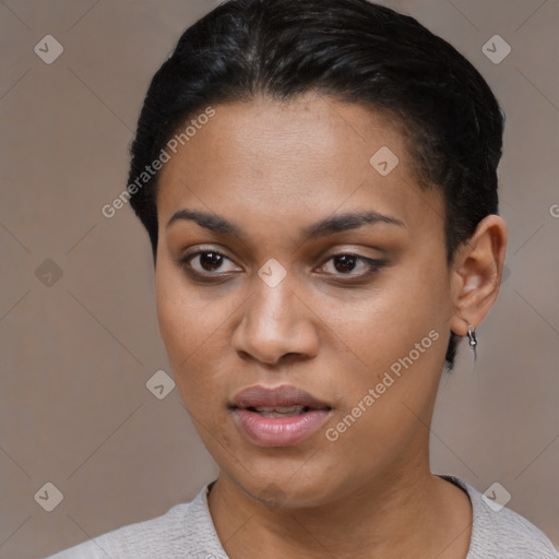 Joyful latino young-adult female with short  black hair and brown eyes