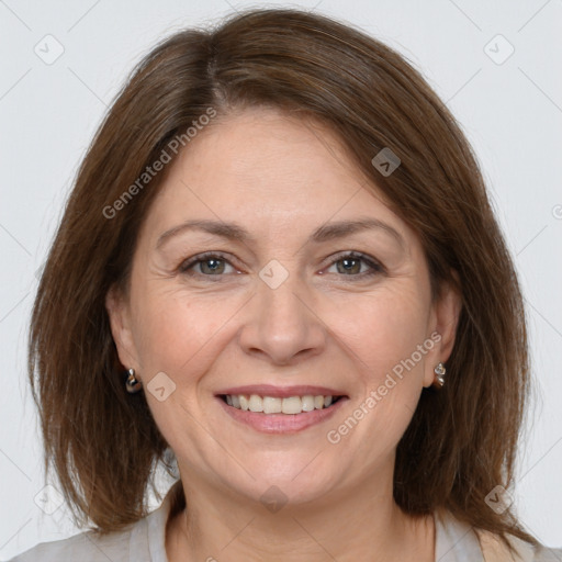 Joyful white adult female with medium  brown hair and brown eyes