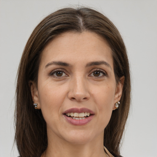 Joyful white young-adult female with long  brown hair and grey eyes