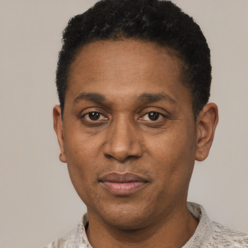 Joyful latino adult male with short  black hair and brown eyes