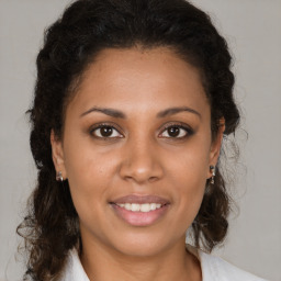 Joyful latino young-adult female with medium  brown hair and brown eyes