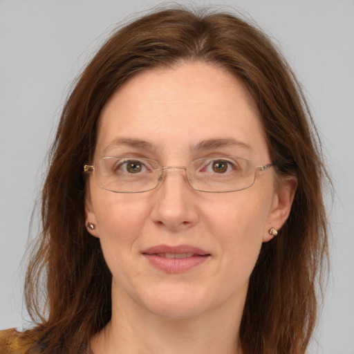 Joyful white adult female with long  brown hair and grey eyes