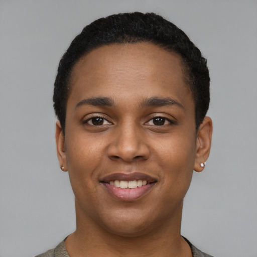 Joyful black young-adult female with short  black hair and brown eyes