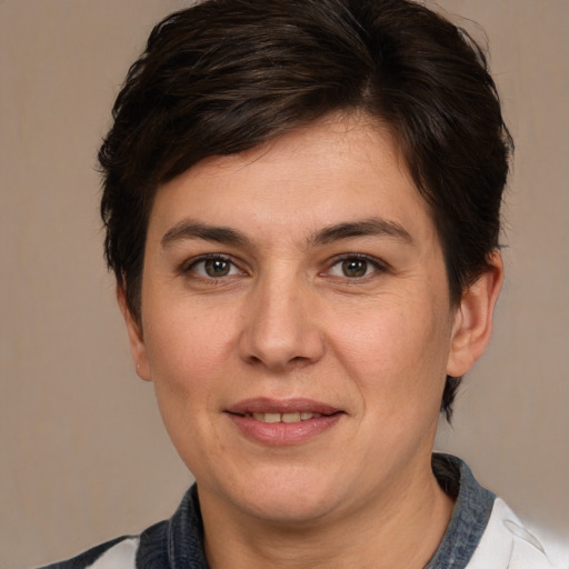 Joyful white adult female with short  brown hair and brown eyes