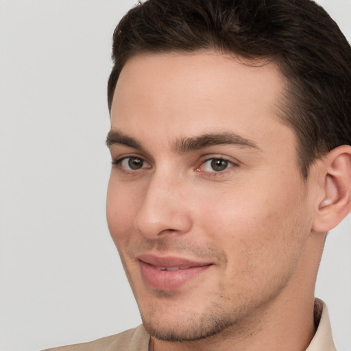 Joyful white young-adult male with short  brown hair and brown eyes