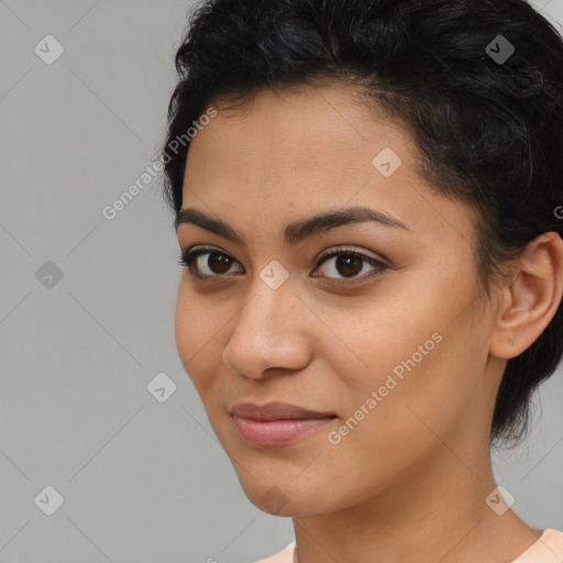 Joyful latino young-adult female with medium  brown hair and brown eyes