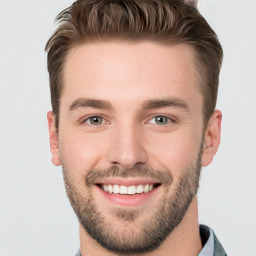 Joyful white young-adult male with short  brown hair and brown eyes