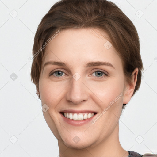 Joyful white young-adult female with short  brown hair and grey eyes