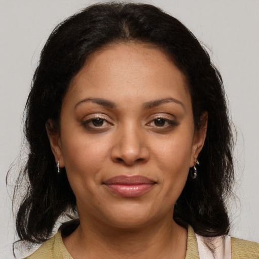 Joyful latino young-adult female with medium  brown hair and brown eyes