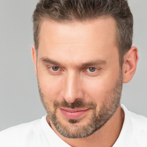 Joyful white adult male with short  brown hair and brown eyes