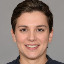 Joyful white young-adult female with short  brown hair and grey eyes