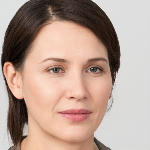 Joyful white young-adult female with medium  brown hair and brown eyes