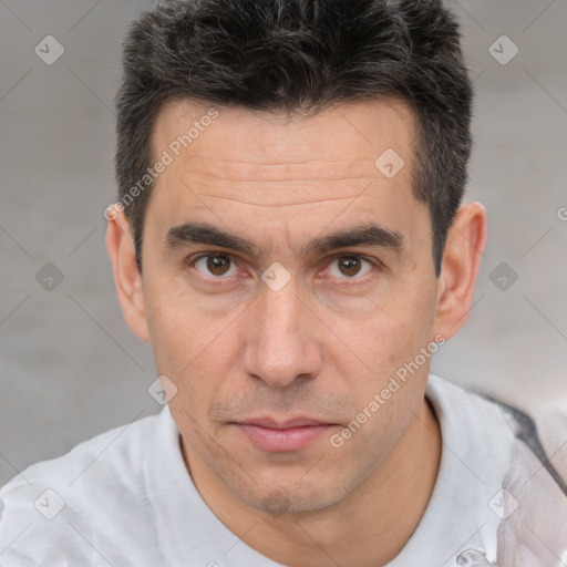 Joyful white adult male with short  brown hair and brown eyes