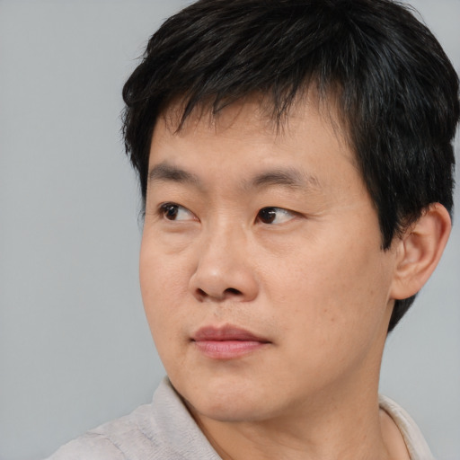 Neutral asian young-adult male with short  brown hair and brown eyes
