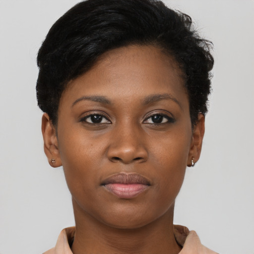 Joyful black young-adult female with short  brown hair and brown eyes