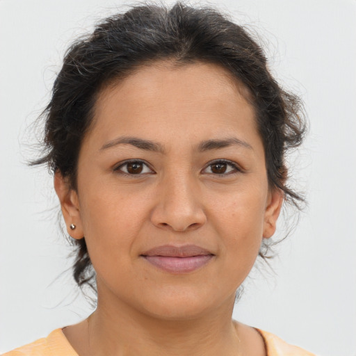 Joyful latino young-adult female with short  brown hair and brown eyes