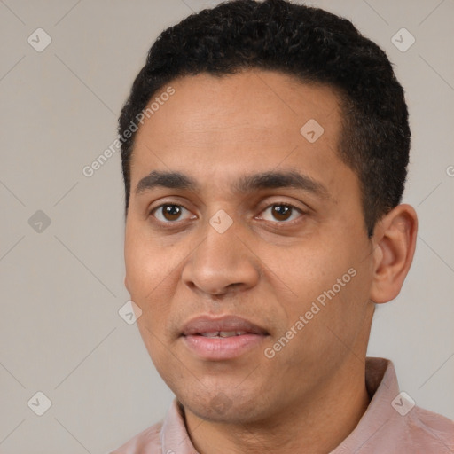 Joyful latino young-adult male with short  black hair and brown eyes
