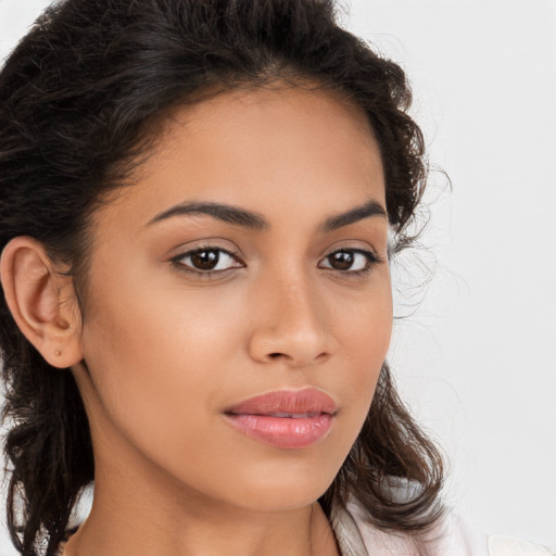 Joyful latino young-adult female with long  brown hair and brown eyes