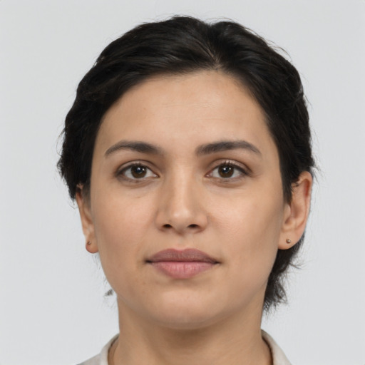 Joyful latino young-adult female with medium  brown hair and brown eyes