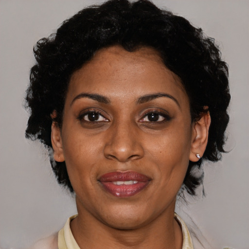 Joyful latino young-adult female with short  black hair and brown eyes