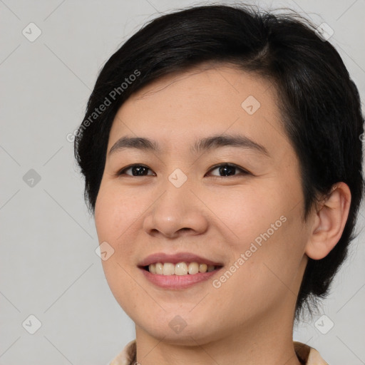 Joyful asian young-adult female with medium  black hair and brown eyes