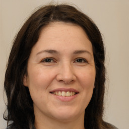 Joyful white adult female with medium  brown hair and brown eyes