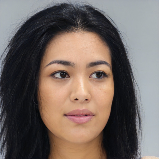 Joyful asian young-adult female with long  black hair and brown eyes