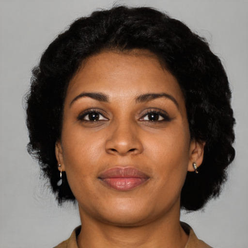 Joyful black young-adult female with short  brown hair and brown eyes