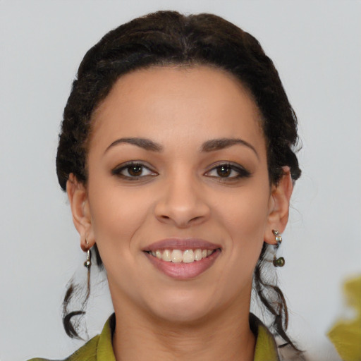 Joyful latino young-adult female with long  brown hair and brown eyes