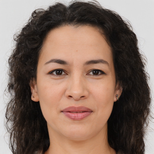 Joyful white adult female with long  brown hair and brown eyes