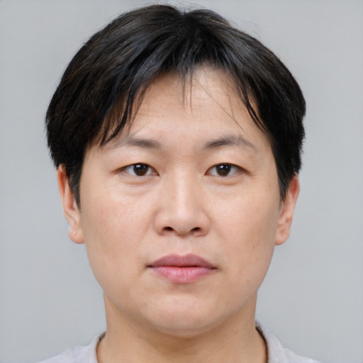 Neutral asian adult male with short  brown hair and brown eyes