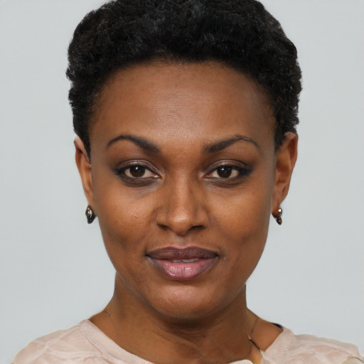 Joyful black young-adult female with short  black hair and brown eyes