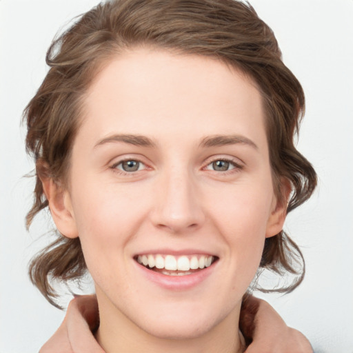 Joyful white young-adult female with medium  brown hair and blue eyes